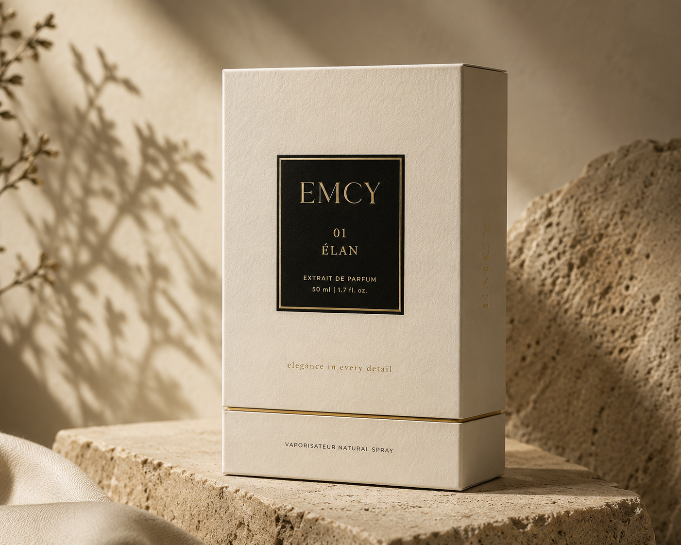 EMCY luxury fragrance packaging on a warm ivory stone pedestal